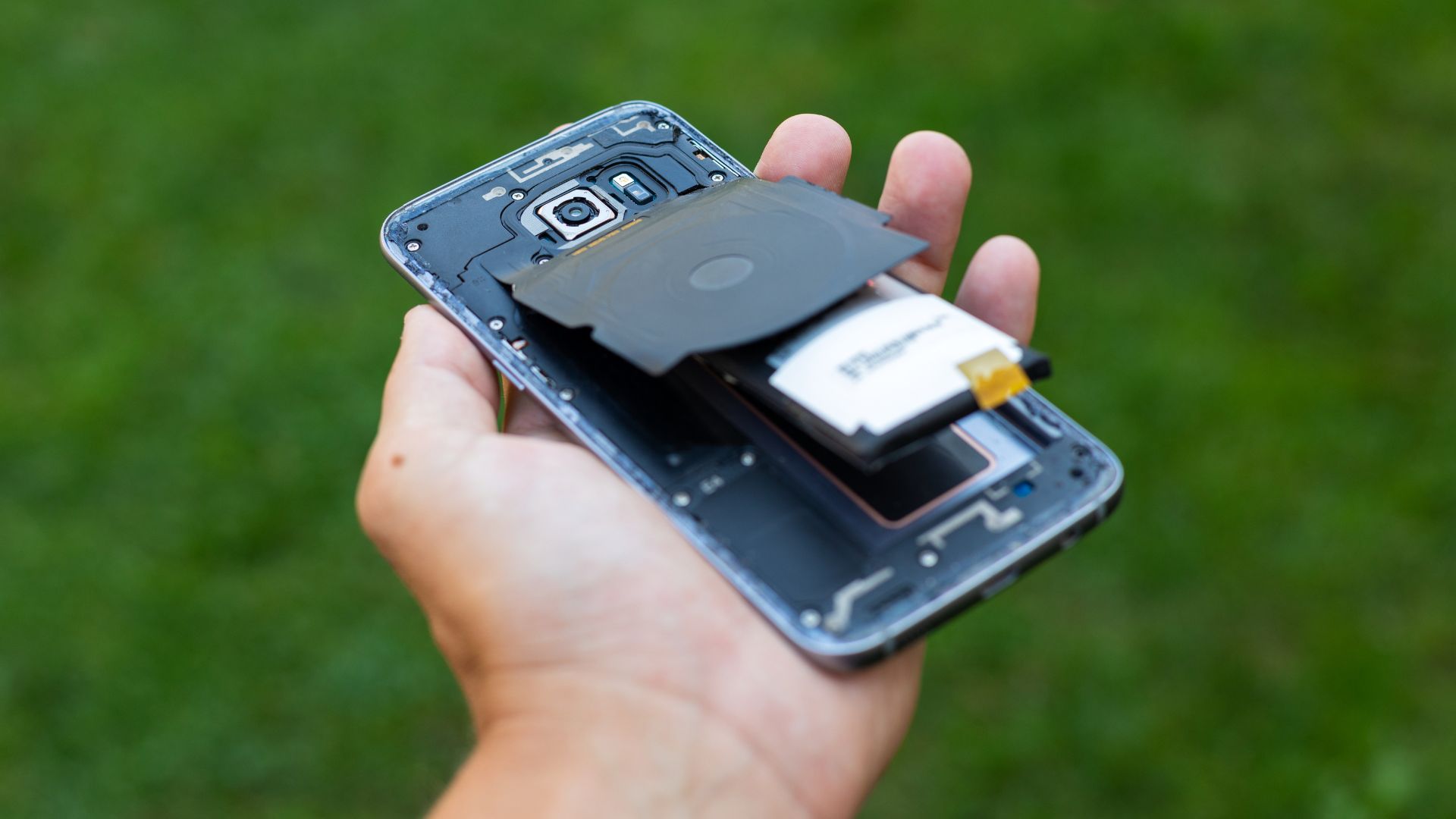 Photo of swelling battery pushing apart internal components of a phone