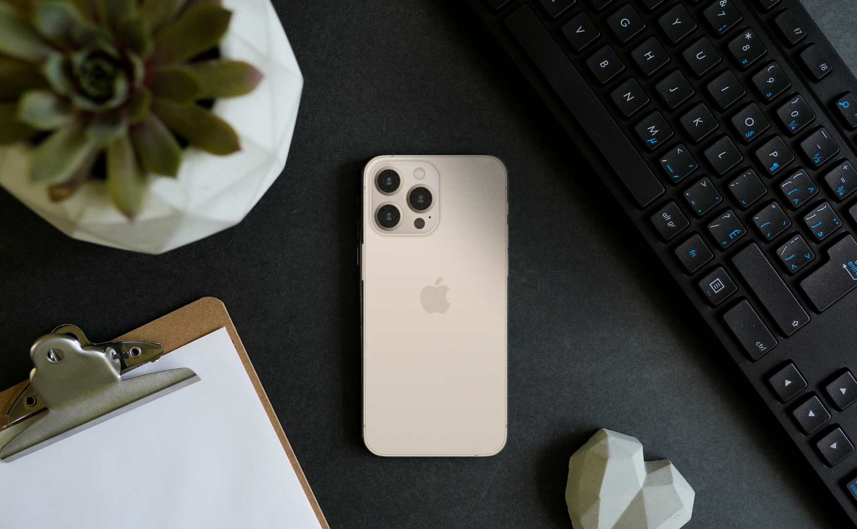 Iphone 13 pro colours: gold on black desk