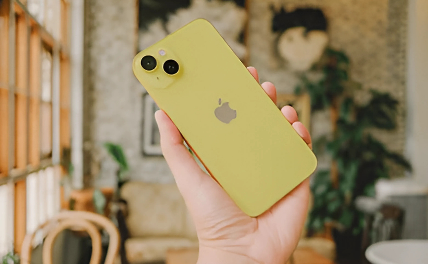 Iphone 14 Colours: A Style Guide For Every Shade Iphone 14 in yellow picture in yellow cafe background