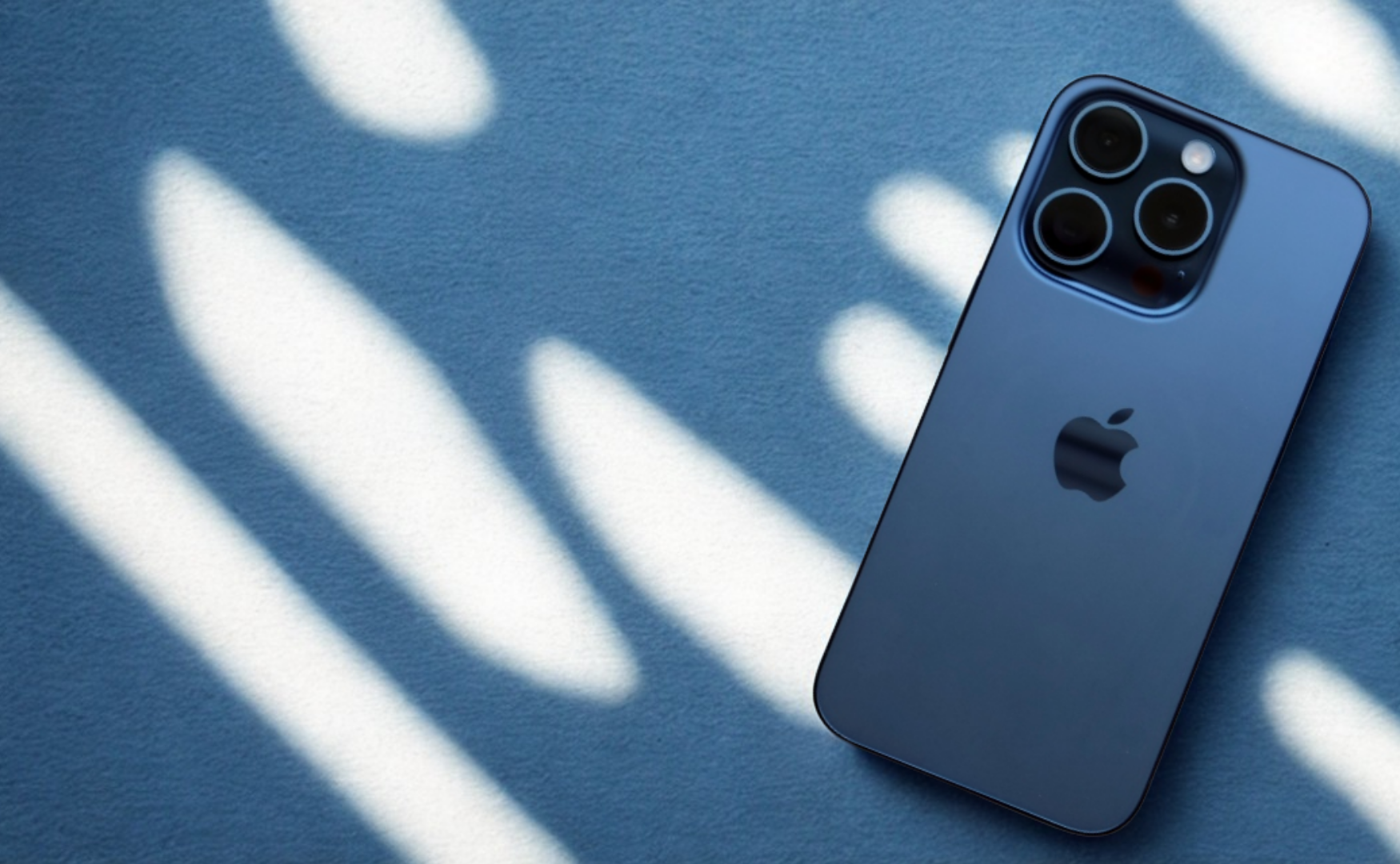 Iphone 16 Pro Colours: A Complete Style And Material Guide Iphone 16 pro in blue titanium on a blue, lit background