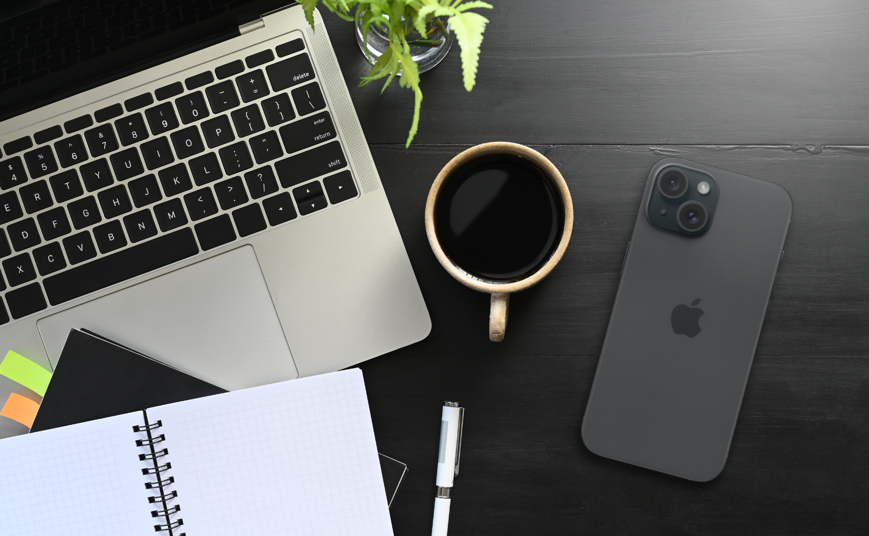 Iphone 15 Colours: Which One Matches Your Mood? Iphone 15 midnight (black) on black desk