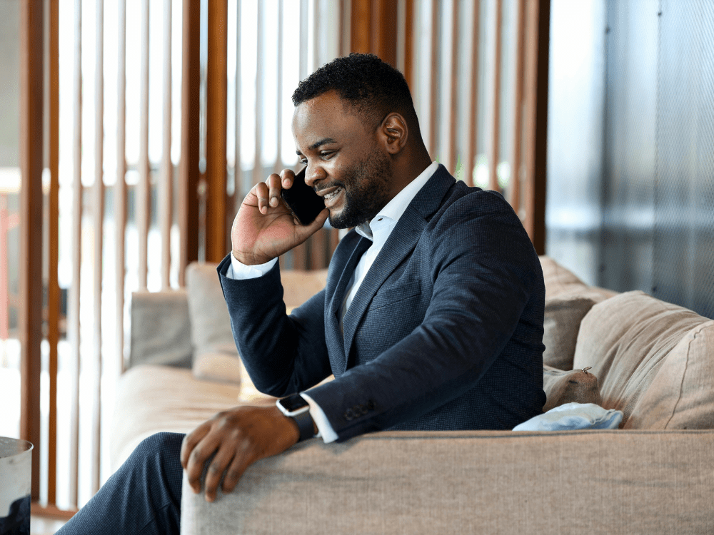 Business man in suit on phone call in modern office space