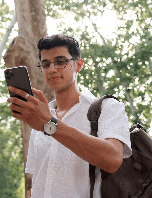 Man using refurbished phone surrounded by nature