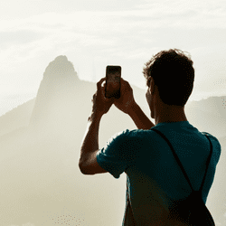 Man taking photo with refurbished phone