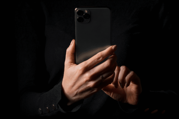 Private mysterious woman doing iphone privacy hack