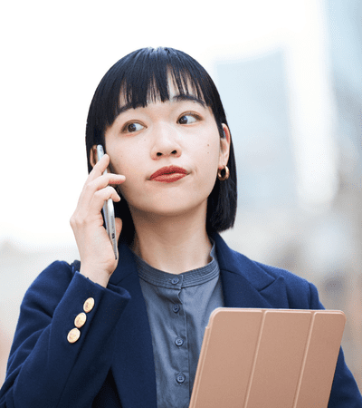 Woman on phone call with ipad in hand