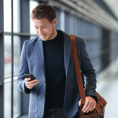 Man in airport checking phone