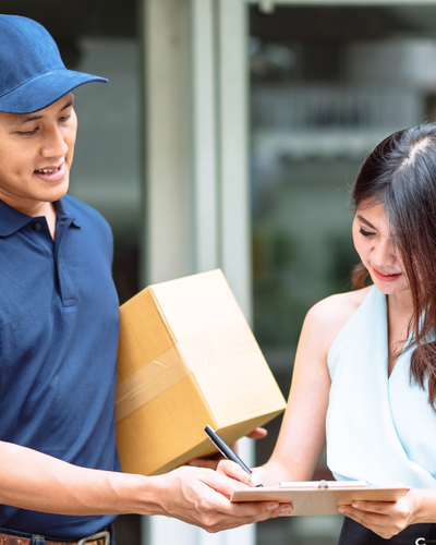 Woman signing for refurbished phone parcel